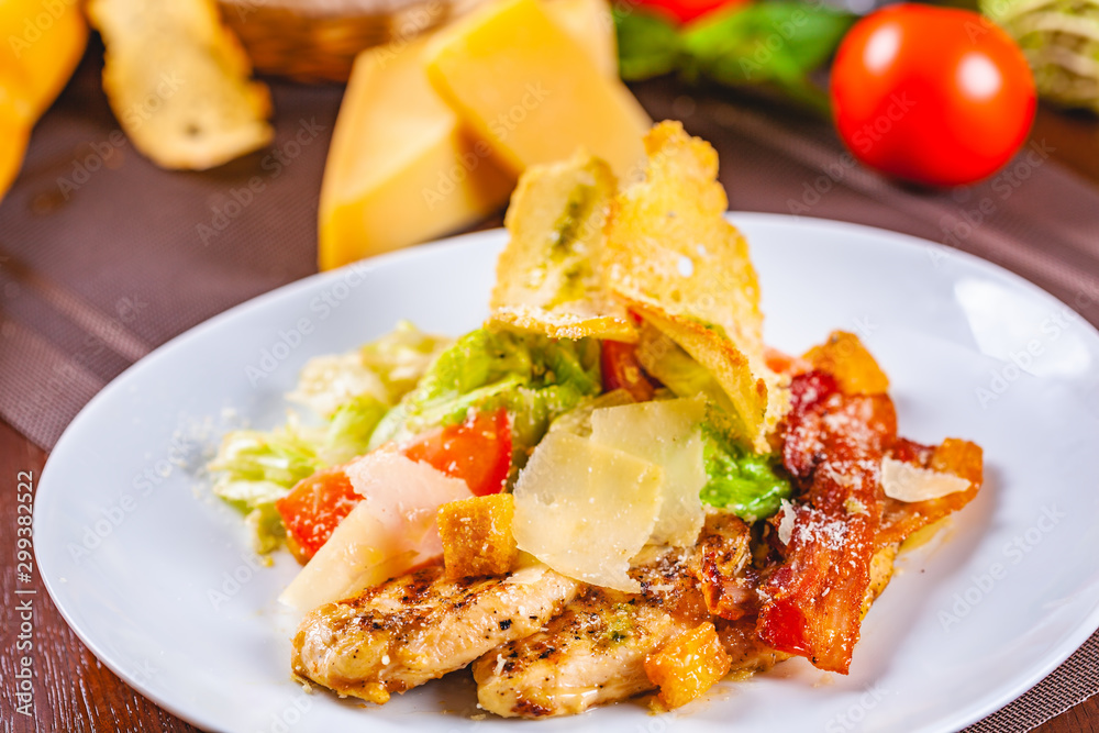 Caesar salad with bacon and chicken on white plate Caesar salad with bacon and chicken on white plate