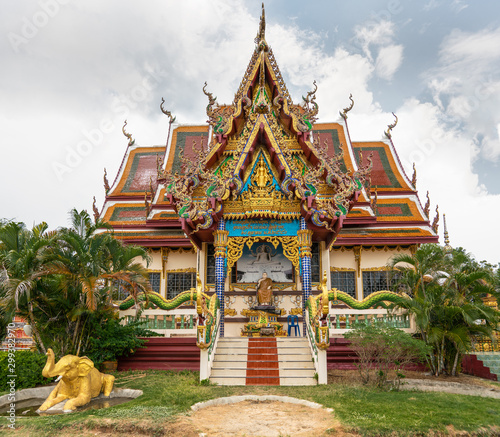 Ko Samui Island, Thailand - March 18, 2019: Wat Laem Suwannaram Chinese Buddhist Temple. Elaborately decorated full of colors front facade with several statues and paintings.