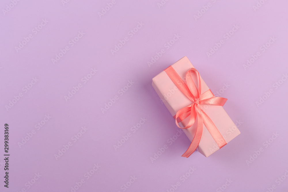 Gift box with ribbon and bow on color background and space for text. Top view - Image Gift box with ribbon and bow on color background and space for text. Top view - Image