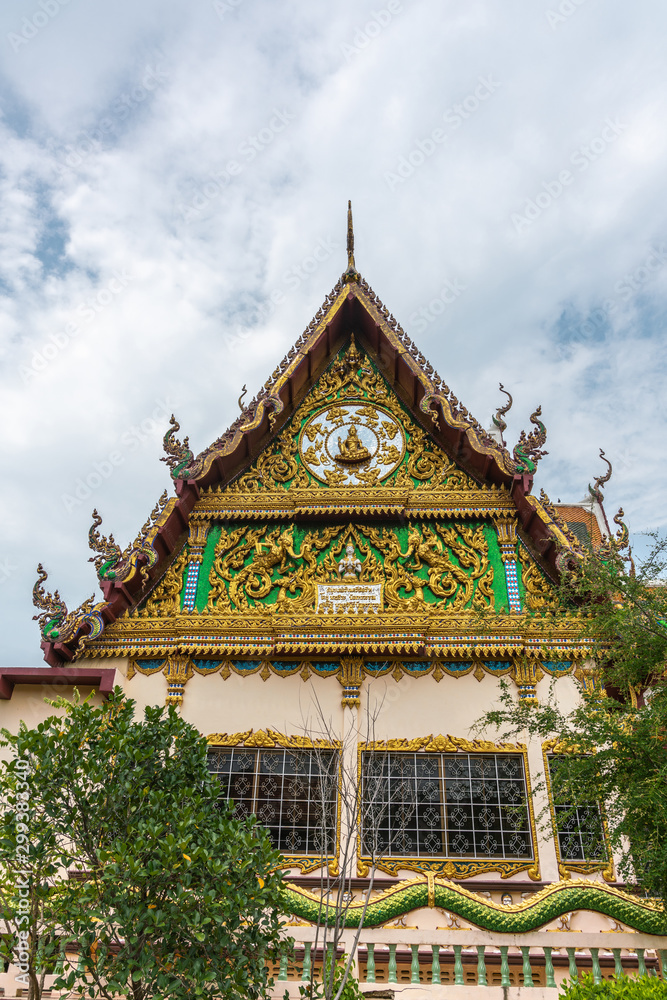 Ko Samui Island, Thailand - March 18, 2019: Wat Laem Suwannaram Chinese Buddhist Temple. Elaborately decorated full of colors south side facade under blue cloudscape and green foliage.