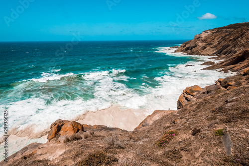 The Indian Ocean and waves breaking on the shore near Cape Agulhas, the southernmost point in Africa. Garden Route, Souther Africa
