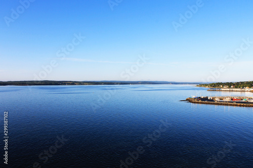 Panoramic view of harbor at North Sydney, Nova Scotia. Clear blue sky, calm water. © Stephen