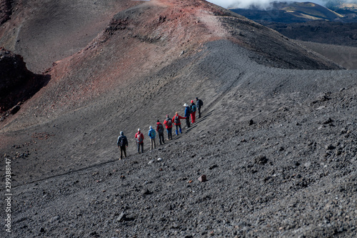Landscape with Group of Hikers on Mount Etna with Black and Red Rocky Surface