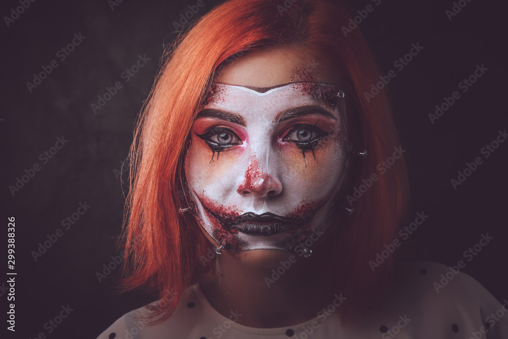 Closeup photo shoot of woman's face with creative scary makeup for Halloween.