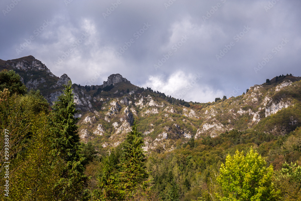 View on the mountains and dark rainy clouds above them