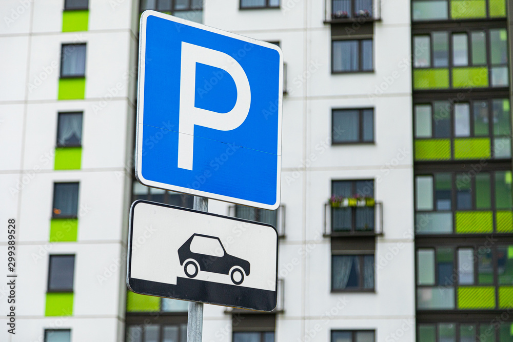 Close-up of roadsign Method of parking vehicle against house building Close-up of roadsign Method of parking vehicle against house building