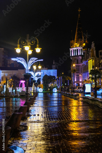 Illuminated christmas street. New Year in Batumi, Georgia. City with New Years decorations. Neon lights and holiday city decorated with glowing Christmas lights