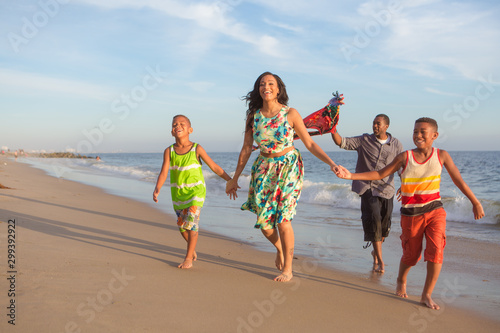 happy family at the beach flying a kite