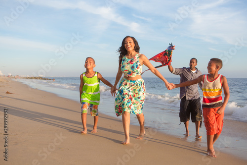 happy family at the beach flying a kite