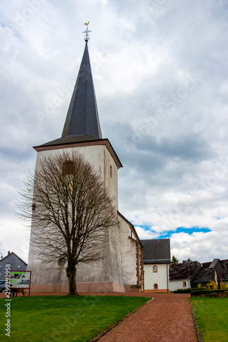 Church of St. Lambert in Manderfeld, Liege Province, Buellingen Municipality, Belgium under overcast April sky photo