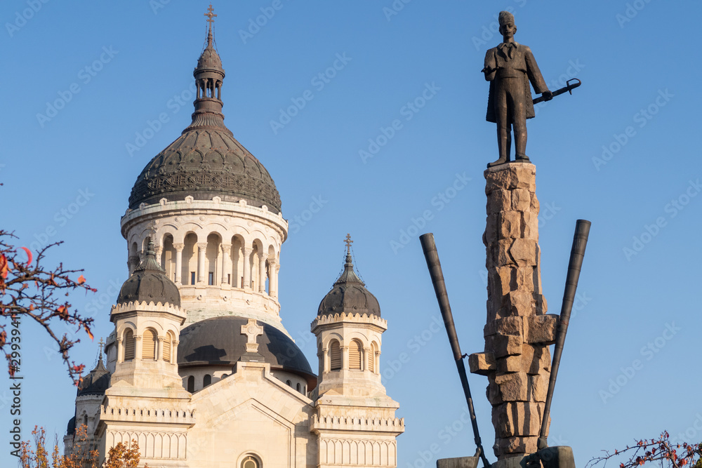 Cluj Napoca, Romania - 24 Oct, 2019: Statue of Avram Lancuand the Orthodox Cathedral of Cluj Napoca, Romania.