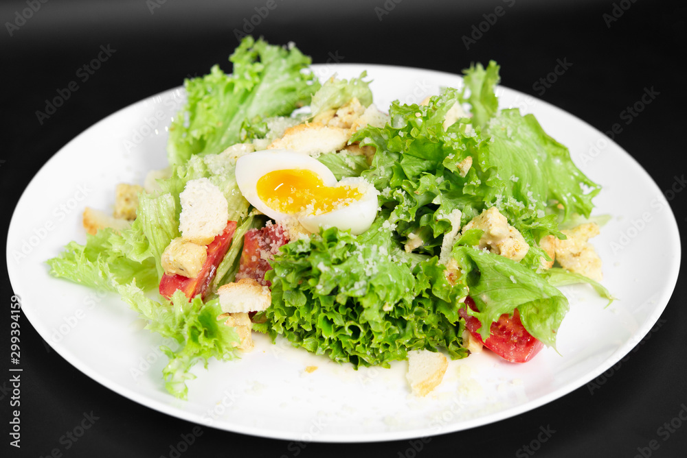 Caesar Salad on a black background Caesar Salad on a black background