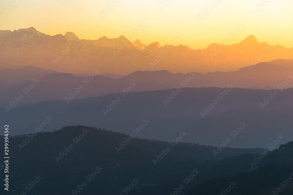 Dawn light hits the peaks of the Himalayan panorama as seen from the Indian town of Kausani in Kumaon, Uttarakhand.