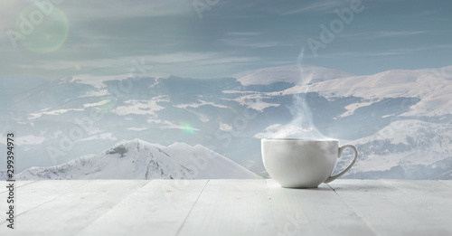 Obraz na plátně Single tea or coffee cup and landscape of mountains on background