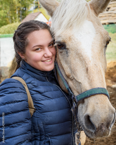Brunette girl with palomino horse