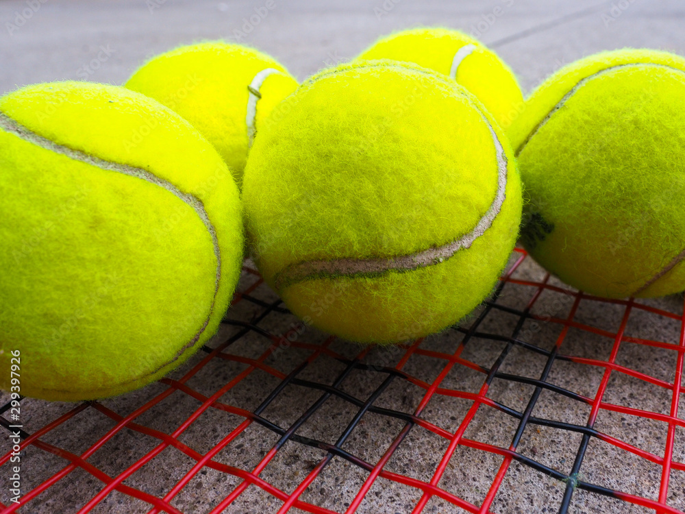 tennis balls on racket