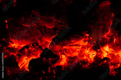 Bright colorful glowing orange-red embers bonfire.