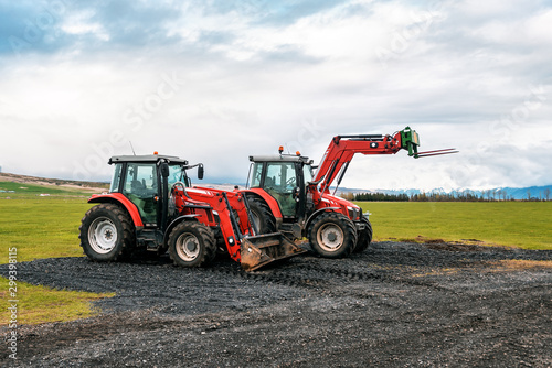 two red tractors in the field