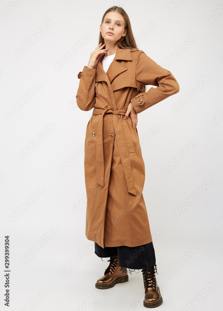 Female trench coat camel color isolated on white background. Female trench coat camel color isolated on white background.