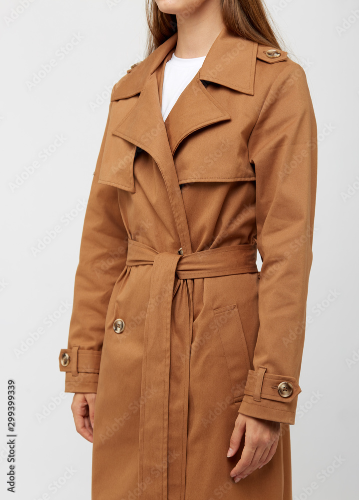 Female trench coat camel color isolated on white background. Stock Photo |  Adobe Stock