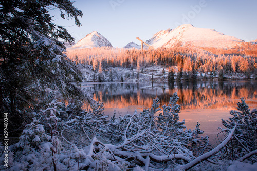 Strbske pleso, High Tatras Slovakia. Sunset on the tarn, snow covered spruce forest and mountains. photo