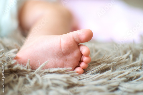 Baby 's heels on soft tuffle mat photo