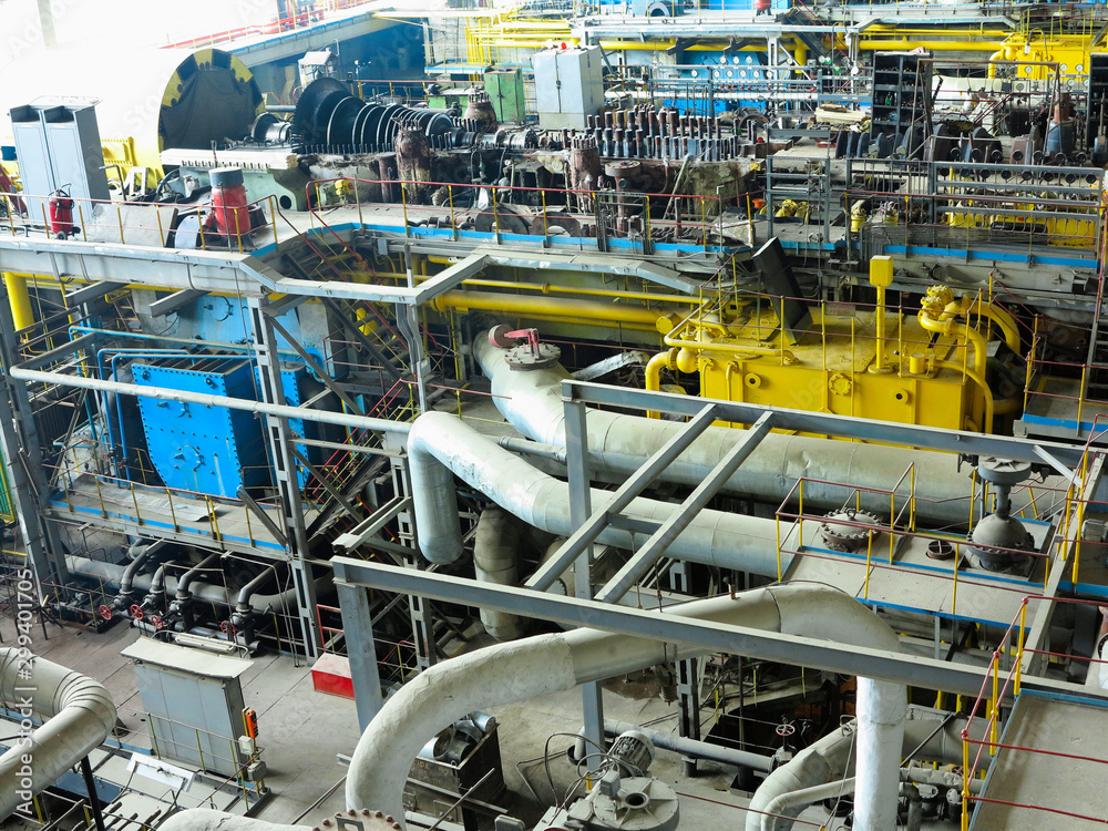 Power generator steam turbine in repair process, machinery, pipes, tubes at power plant Power generator steam turbine in repair process, machinery, pipes, tubes at power plant