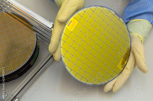 Photography Silicon Wafers in steel holder box take out by hand in gloves