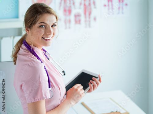 Doctor woman checking medical data on tablet pc