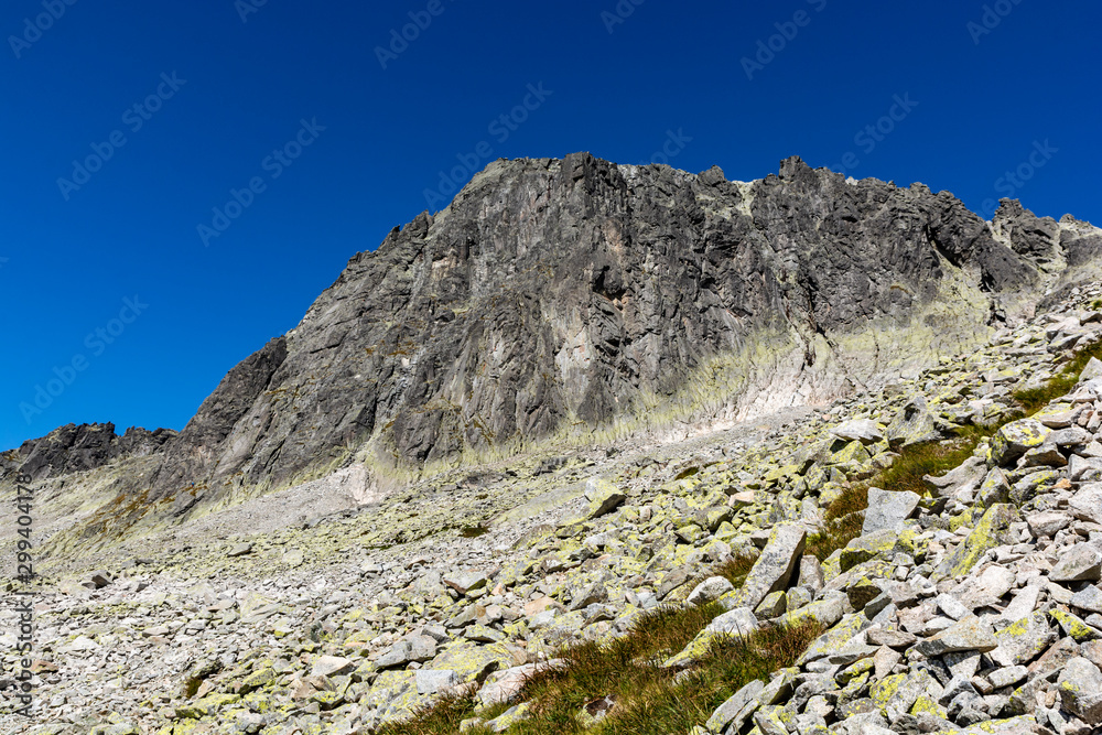Mountain landscape. View of the wall on which mountaineers climb to get to the top - Baranie rohy (Baranie Rogi). Tatra Mountains, Slovakia.