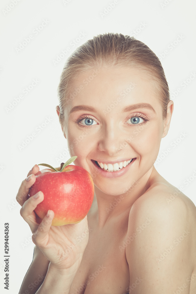 Cute young lady holding red apple while isolated on white background Cute young lady holding red apple while isolated on white background