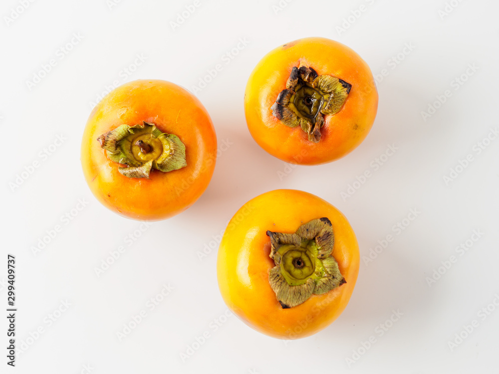 Top view of three persimmon isolated on white background. Top view of three persimmon isolated on white background.