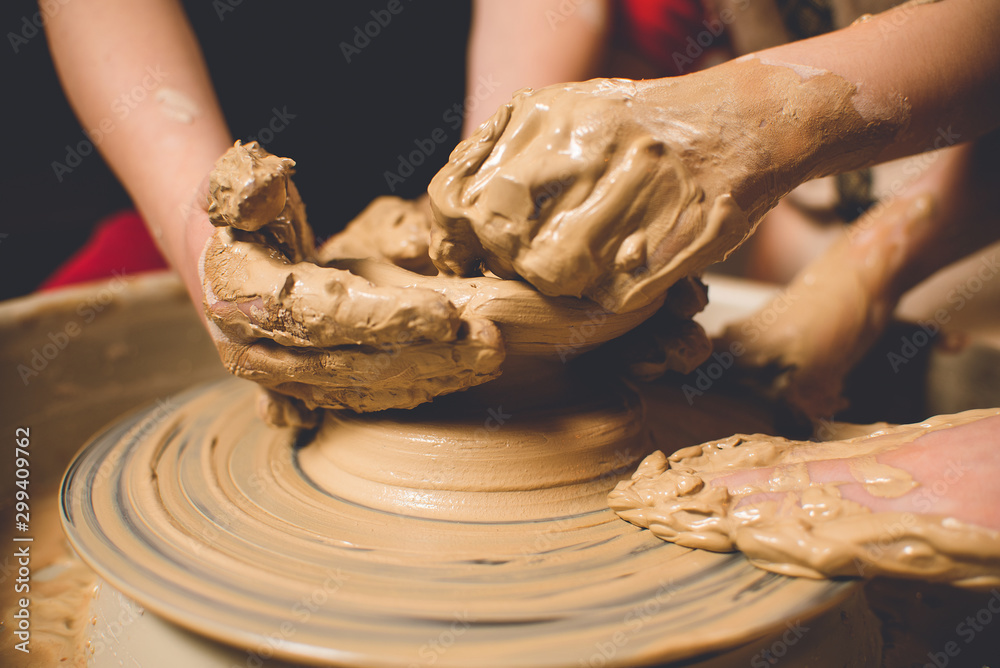 Children's hands make a mold of clay. Pottery