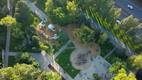 children playground in park area in city in sunny evening, aerial view