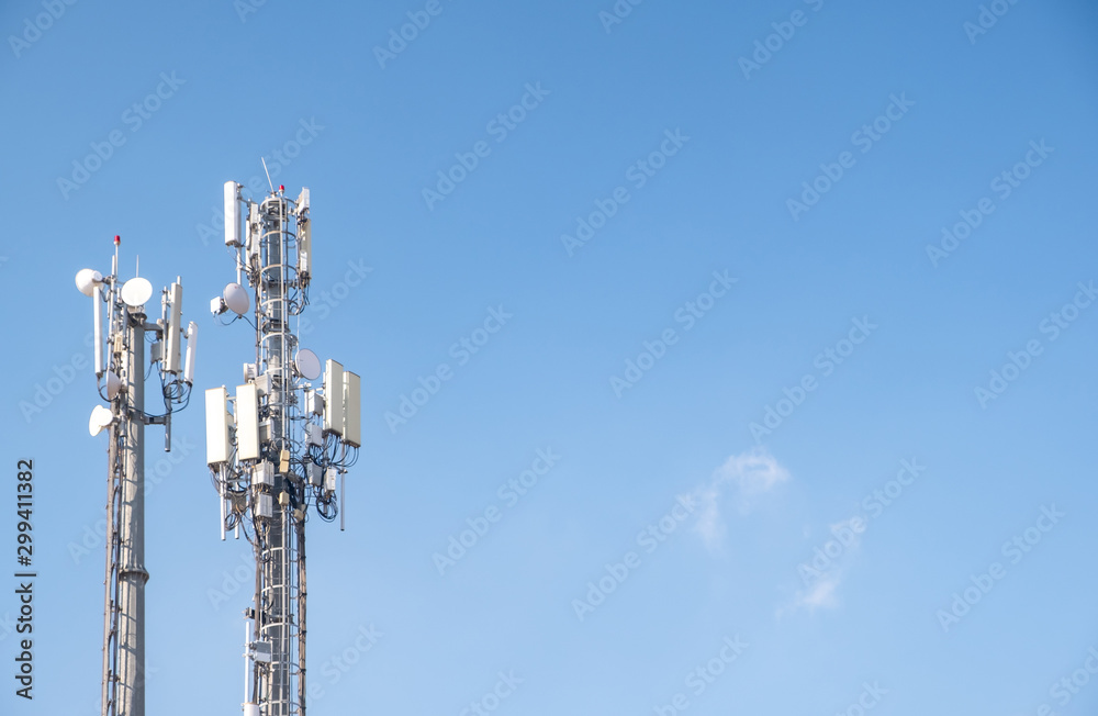 Cellular Base Station or Base Transceiver Station. Telecommunication tower. Wireless Communication Antenna Transmitter. 3G, 4G and 5G Cell Site with cloudy blue sky.