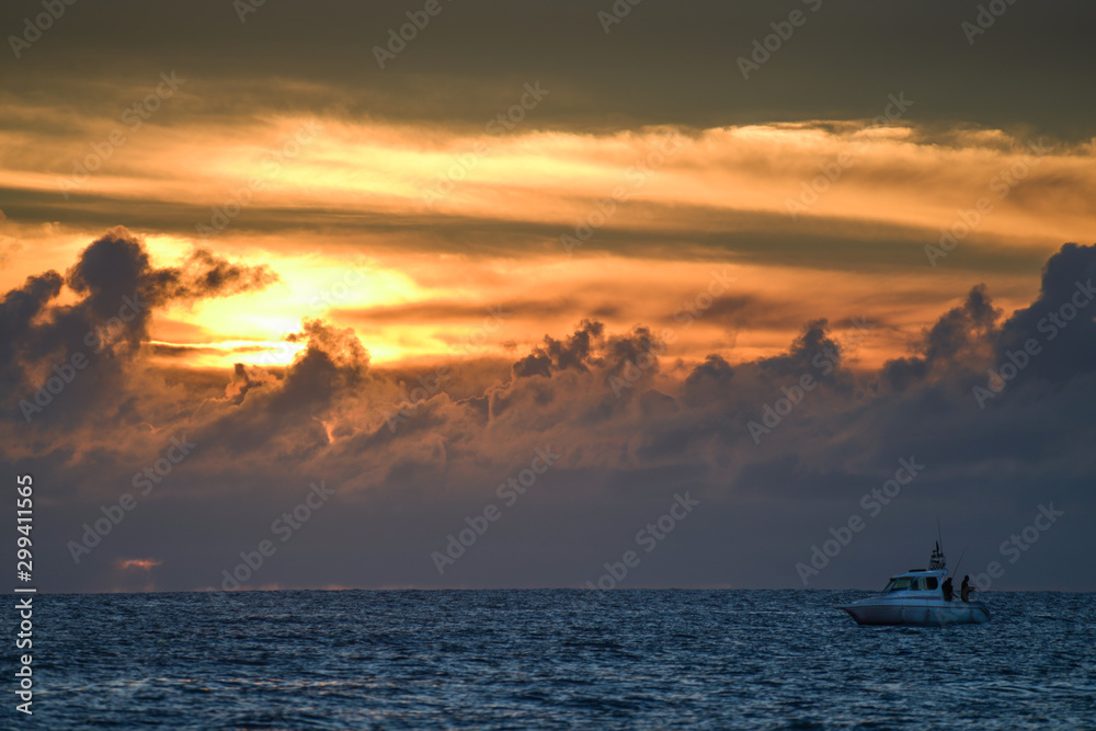 Sea fishing under dramatic sunset