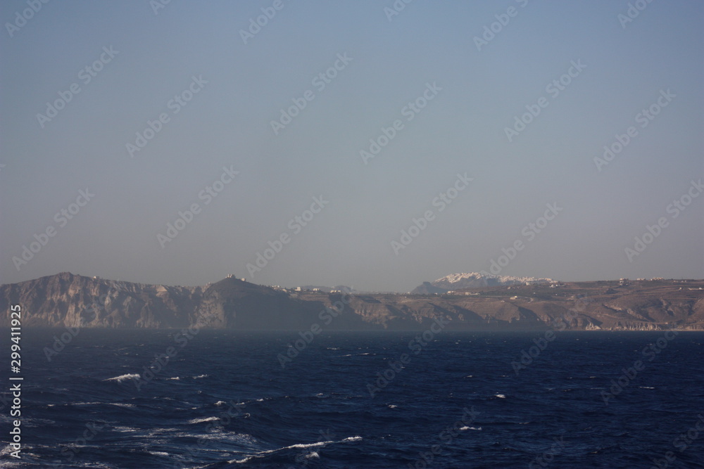 Aegean sea: sand, water, ripples, reflections, waves and lighthouses