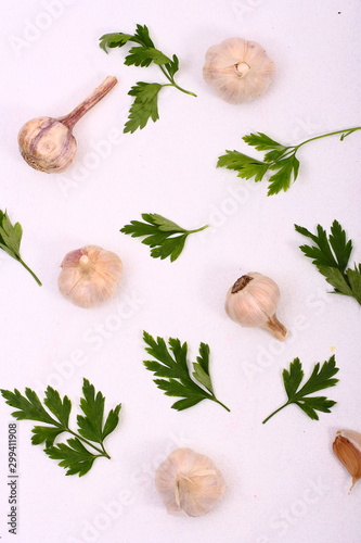 Parsley and garlic on white background.