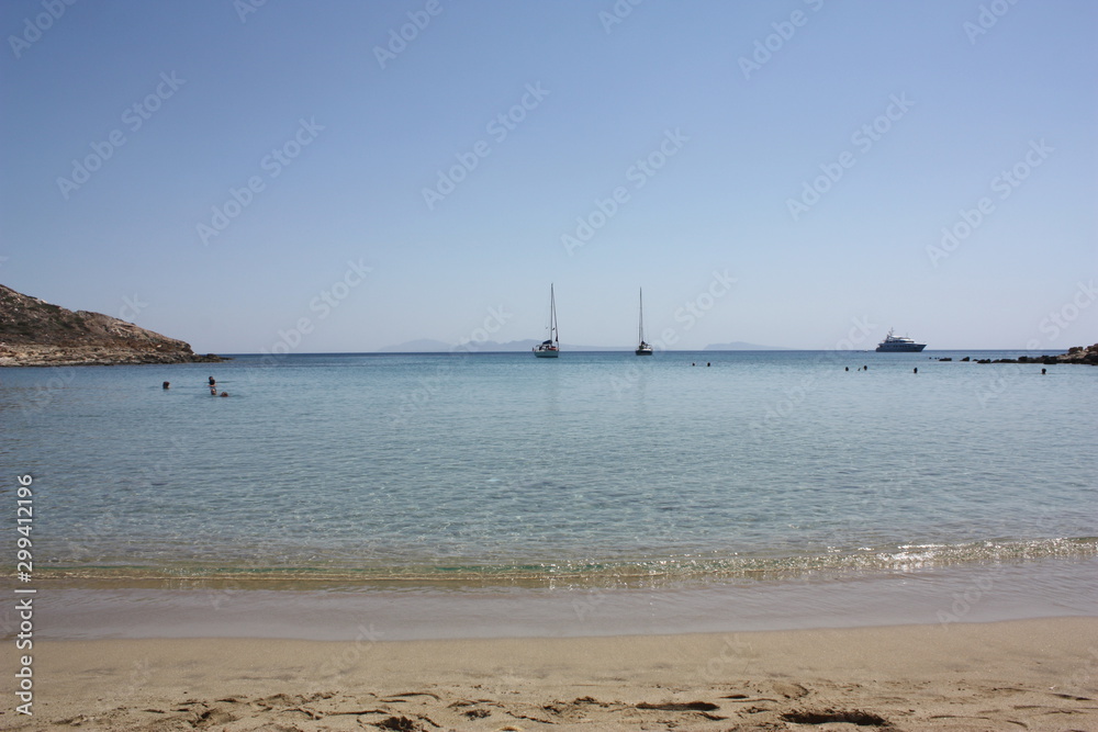Aegean sea: sand, water, ripples, reflections, waves and lighthouses