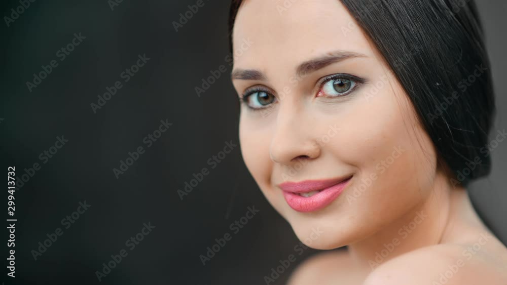 Sexy smiling woman naked soft smooth skin posing at black studio background tilt up Sexy smiling woman naked soft smooth skin posing at black studio background tilt up