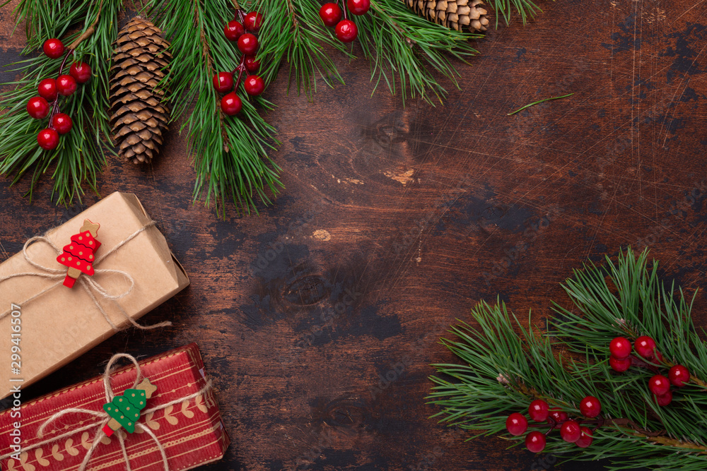 Gift boxes and fir tree branches on wooden background. Christmas greeting card. Top view. Copy space - Image Gift boxes and fir tree branches on wooden background. Christmas greeting card. Top view. Copy space - Image