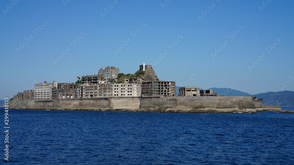 Gunkanjima is an abandoned city of a coal miners on the Hashima island in Japan. Panoramic view. Gunkanjima is an abandoned city of a coal miners on the Hashima island in Japan. Panoramic view.
