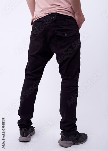 man in jeans, denim pants close up on white background, black jeans.
