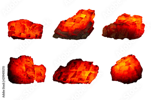 Different pieces of hot coal isolated on a white background close up. A group of burning coals of various shapes and temperatures. Raw coal mine nuggets on fire for power and fuel  industry