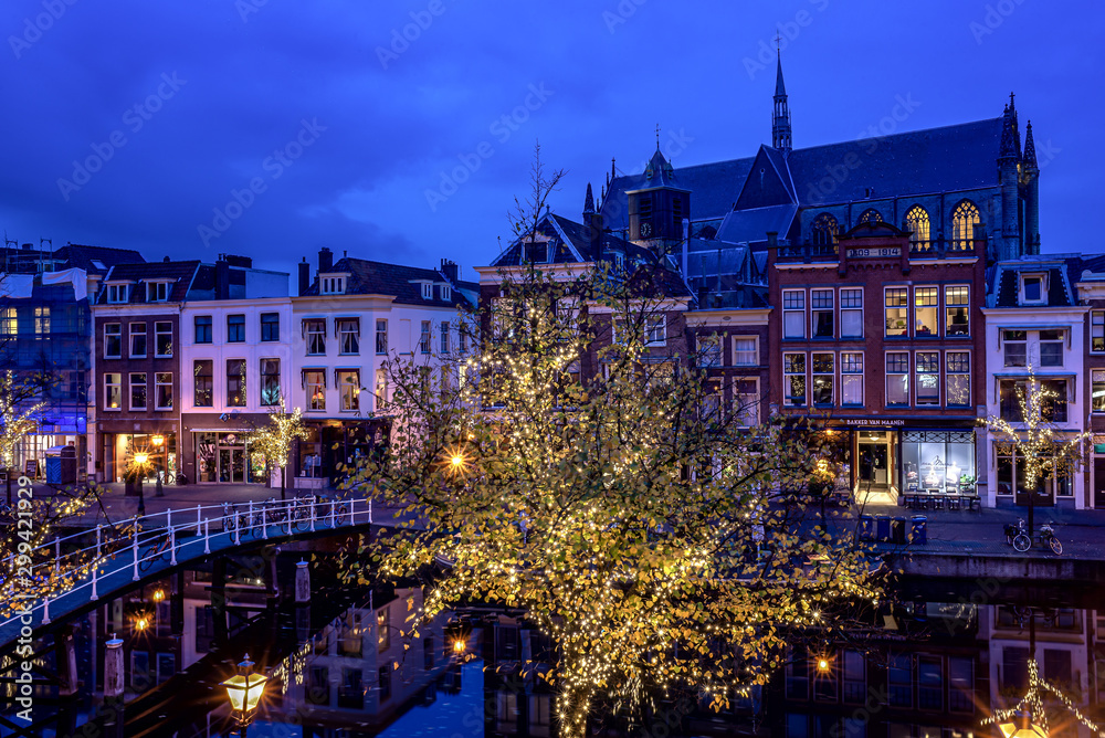 Leiden, Netherlands, 20 October 2019: Beautiful autumn night scene in Leiden, The Netherlands still reflections in the canal water