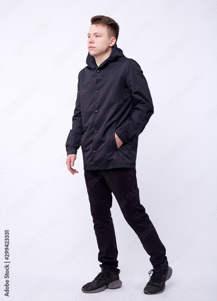 Young good looking man standing wearing a blue jacket. White background. Young good looking man standing wearing a blue jacket. White background.