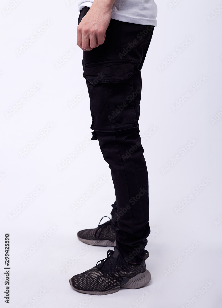 man in jeans, denim pants close up on white background, black jeans. man in jeans, denim pants close up on white background, black jeans.