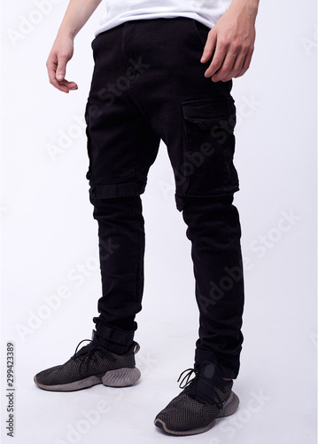 man in jeans, denim pants close up on white background, black jeans.