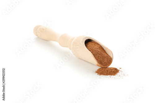 Wood scoop with cinnamon powder isolated on white background