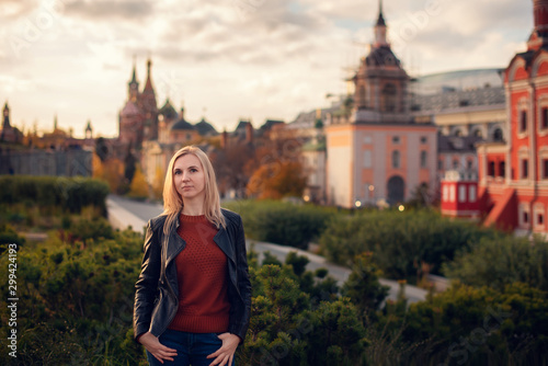 portrait of a young beautiful blonde in a hat on a background of the city of Moscow